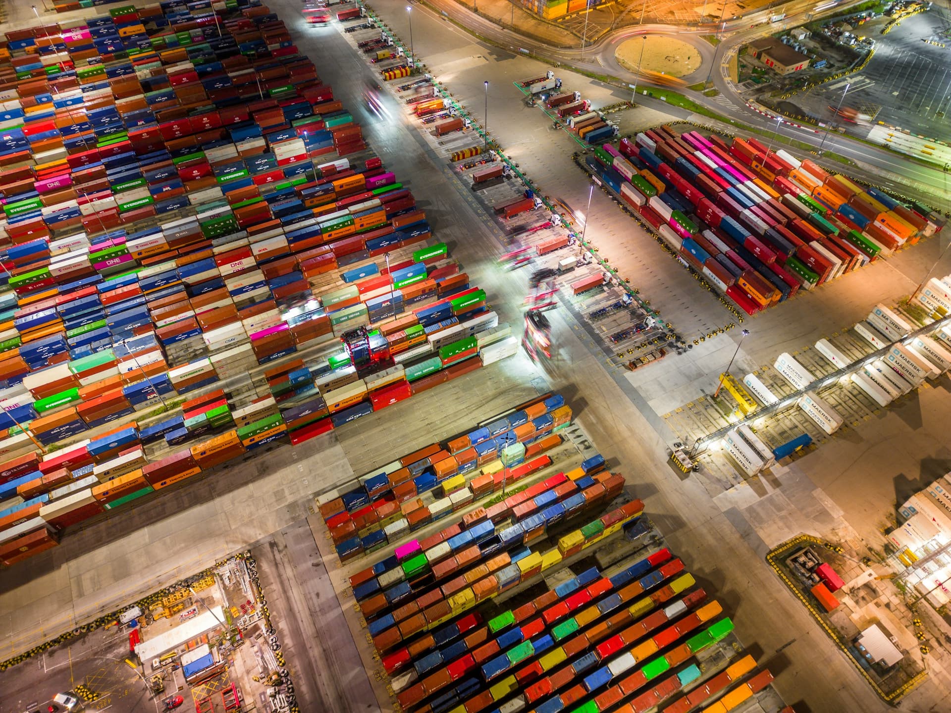 Southampton container docks from the air at night, lorries moving between the stacks.