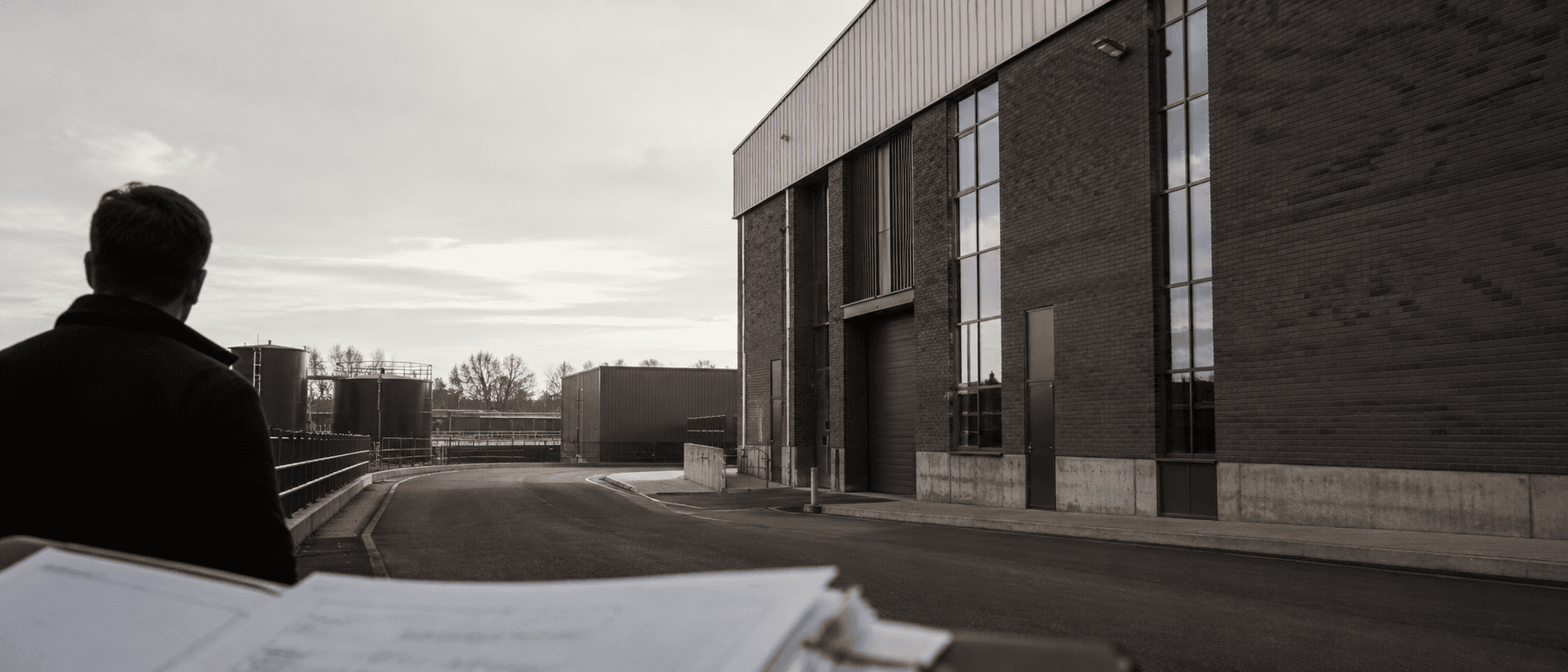 A Stratton specialist surveying a commercial industrial site from the approach road.
